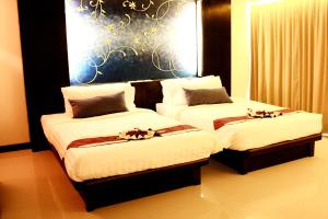 Postel nebo postele na pokoji v ubytování Khaolak Orchid Beach Resort - SHA Extra Plus