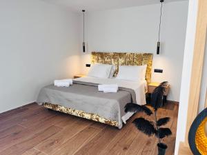 a bedroom with a large bed with two pillows at Nobile Boutique Hotel in Agios Gordios