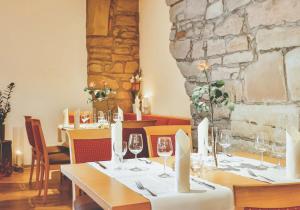 a dining room with a table with wine glasses at Hotel Restaurant Zehntscheune in Sinsheim