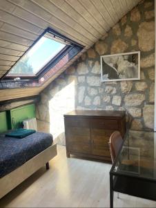 a bedroom with a bed and a stone wall at Private Room in Esch-sur-Alzette in Esch-sur-Alzette