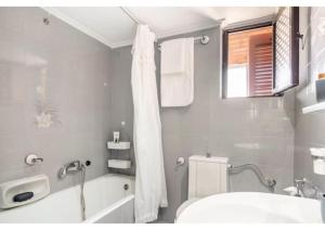 a bathroom with a tub and a toilet and a sink at Villa Dorita in Petrití +35 photos