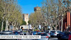 a parking lot with cars parked in front of a castle at Arcave Luxury Apartment in Sirmione