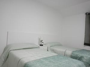 dos camas sentadas una al lado de la otra en una habitación en Casa Eloy, en Barreiros
