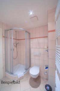 a bathroom with a shower and a toilet at Strandläufer Classic 105 in Granzow
