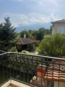 a balcony with a bench and a house at To Rodakino in Litochoro