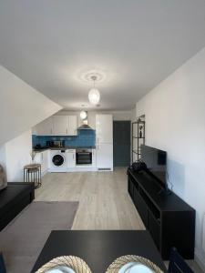 a large living room with a black table and a kitchen at 1 Bedroom Flat in Bedford in Bedford