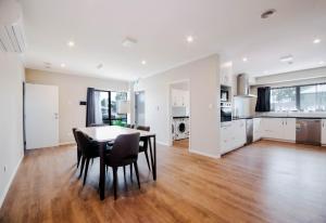 a kitchen and dining room with a table and chairs at ACL Studio Units in Auckland