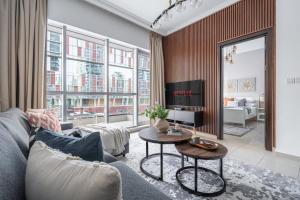 a living room with a couch and a table at GuestReady - Comfort Stay l Close To Marina Mall in Dubai
