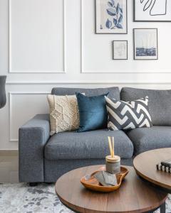 a living room with a couch and a table at GuestReady - Comfort Stay l Close To Marina Mall in Dubai +28 photos