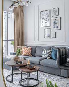 a living room with a blue couch and a table at GuestReady - Comfort Stay l Close To Marina Mall in Dubai