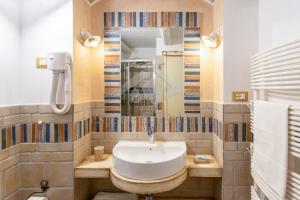 a bathroom with a sink and a mirror at SANTA LUCIA DIMORA in Taviano