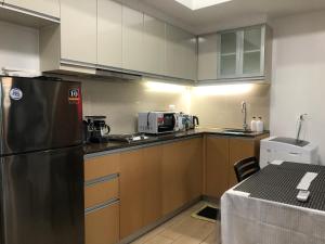 a kitchen with a stainless steel refrigerator and cabinets at Victorian place - Simple yet Luxurious flat in BGC in Manila +9 photos