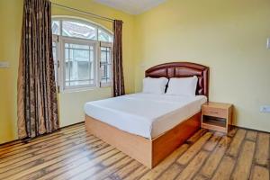a bedroom with a large bed and a window at Lit Homestay in Srinagar
