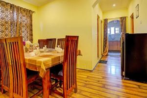 a dining room with a long table and chairs at Lit Homestay 5 Mins from Airport in Srinagar