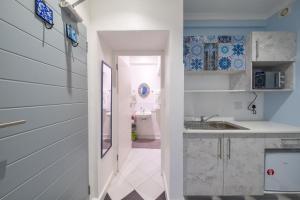 a kitchen with a sink and a counter top at Cosy and Central in Claremont in Cape Town +5 photos