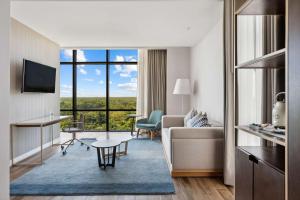 a hotel suite with a living room with a view at Avani Cancun Airport -previously NH Cancun Airport- in Cancún