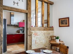 a kitchen with red cabinets and a table at Holiday Home Les écuries de Callenville by Interhome in Trouville-sur-Mer