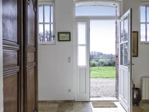 an open door with a view of a field at Holiday Home Les écuries de Callenville by Interhome in Trouville-sur-Mer