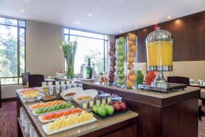 a buffet with fruits and vegetables on a table at NH Collection Bogota Hacienda Royal in Bogotá
