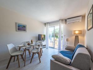 a living room with a couch and a table at Apartment Caesar Domus-1 by Interhome in Saint-Tropez