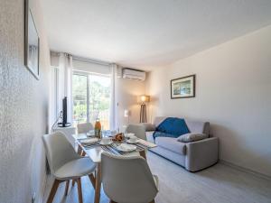 a living room with a table and a couch at Apartment Caesar Domus-1 by Interhome in Saint-Tropez +15 photos