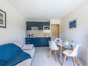 a living room with a couch and a table and chairs at Apartment Caesar Domus-1 by Interhome in Saint-Tropez