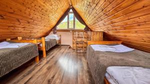 a room with three beds in a log cabin at Cottage Gudauri in Gudauri