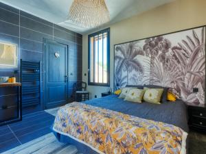 a blue bedroom with a bed and a blue wall at Holiday Home La Cabane Andernosienne by Interhome in Andernos-les-Bains