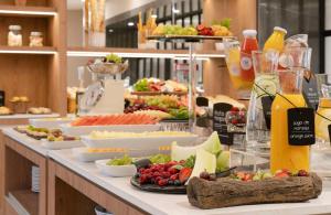 a buffet line with appetizers and fruits and vegetables at NH Ciudad de Santiago in Santiago