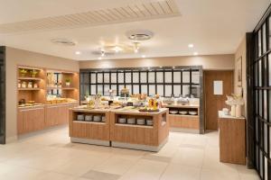 a large kitchen with a buffet in a restaurant at NH Ciudad de Santiago in Santiago
