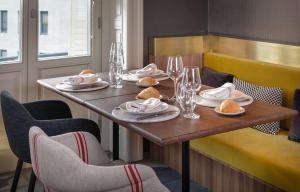 a table in a restaurant with plates of food on it at NH Collection Madrid Gran Vía in Madrid