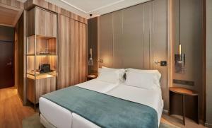a bedroom with a large bed in a room at NH Collection Madrid Gran Vía in Madrid