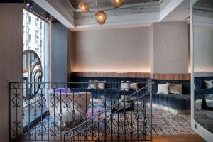 a living room with a couch and a table at NH Collection Madrid Gran Vía in Madrid