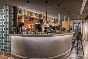 a bar in a restaurant with a counter at NH Collection Madrid Gran Vía in Madrid