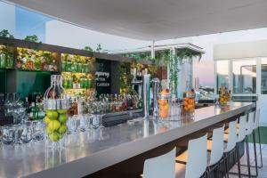 a bar with a lot of bottles and glasses at NH Collection Madrid Gran Vía in Madrid