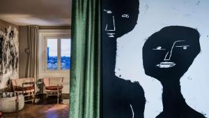 a painting of two women on a wall in a room at NH Collection Madrid Gran Vía in Madrid