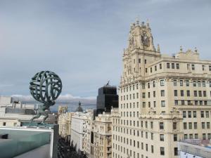 a view of a tall building with a clock tower at NH Collection Madrid Gran Vía in Madrid