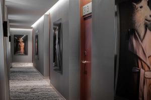 a hallway with many paintings on the walls at NH Collection Madrid Gran Vía in Madrid