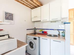 a kitchen with a washing machine and a sink at Studio Casa Maza Corta by Interhome in Lumio