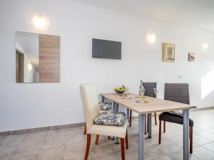 a dining room with a wooden table and chairs at Apartment B&B-5 by Interhome in Ližnjan