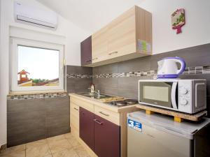 a kitchen with a microwave oven and a sink at Apartment B&B-5 by Interhome in Ližnjan