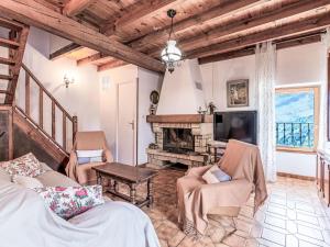 a living room with a fireplace and a tv at Holiday Home Casa Piana by Interhome in San-Giovanni-di-Moriani
