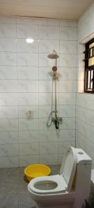 W łazience znajduje się biała toaleta i prysznic. w obiekcie VENUS APARTMENT Kigali w mieście Kigali