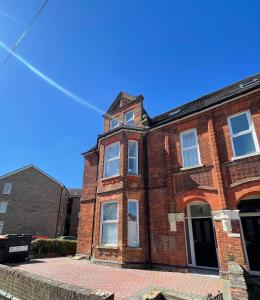 a brick building with a tower on top of it at 1 Bedroom Flat in Bedford in Bedford