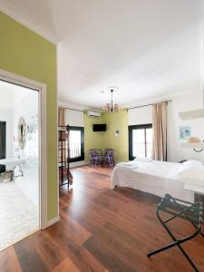a bedroom with a large bed and a living room at NeapolitanTrips Hotel in Naples