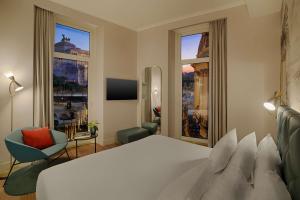 a hotel room with a bed and a large window at NH Collection Roma Fori Imperiali in Rome