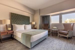 Ένα ή περισσότερα κρεβάτια σε δωμάτιο στο Tivoli Oriente Lisboa Hotel