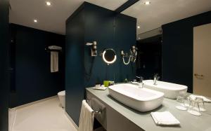 a bathroom with a sink and a toilet at Tivoli Oriente Lisboa Hotel in Lisbon