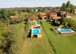 an aerial view of a house with two swimming pools at Lily's Rural House in Jarki Horvatićevi