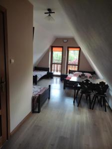 a attic room with a table and a bed at Środkowa 20 in Białka Tatrzanska
